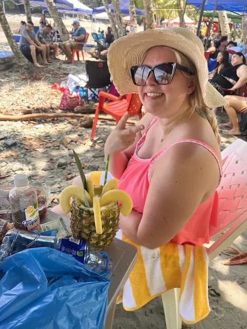 A Casa Cascada guest enjoying a fresh pineapple drink from a beachside vendor at Playa Ventanas