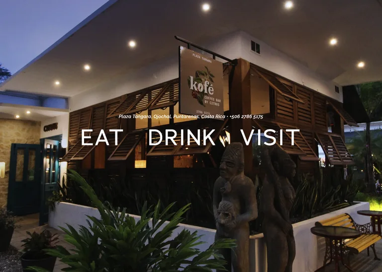 Citrus and Kofé coffee bar storefront at Plaza Tangara in Ojochal in the evening
