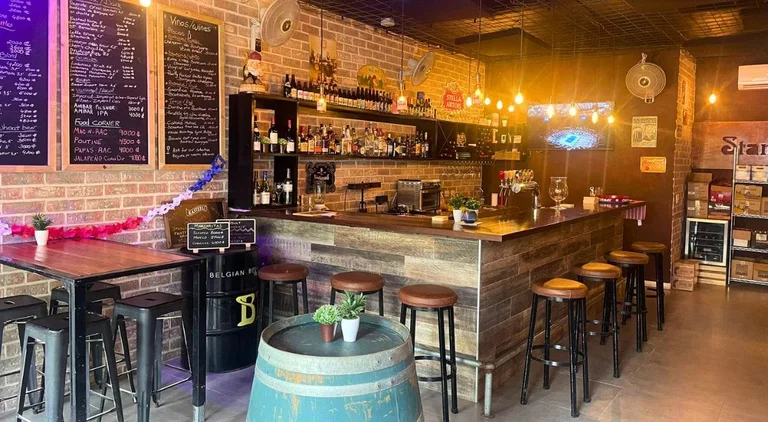 Stan’s Café’s bar with Belgian beer taps, bottles, and chalkboard menus