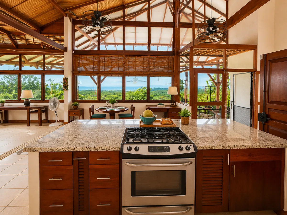 Kitchen island and gas range looking out toward windows framing the Pacific Ocean