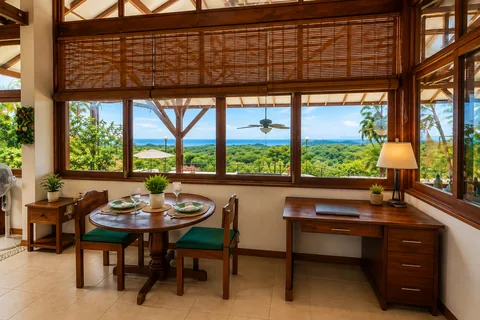 Indoor dining table and desk nook with an ocean view through the windows